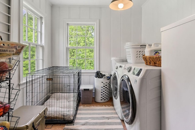 36 Hillcrest Dr, Sparta, TN 38583 - laundry room featuring separate washer and dryer, healthy amount of natural light, light wood finished floors, and a decorative wall