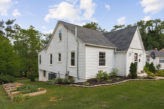 36 Hillcrest Dr, Sparta, TN 38583 - view of home's exterior with cooling unit, a yard, a shingled roof, and a garden