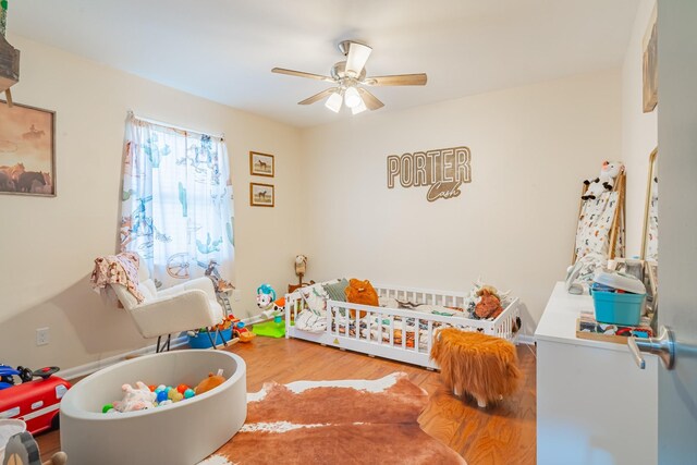1689 Pleasant Ridge Rd, Huntland, TN 37345 - bedroom featuring a nursery area, wood finished floors, and a ceiling fan