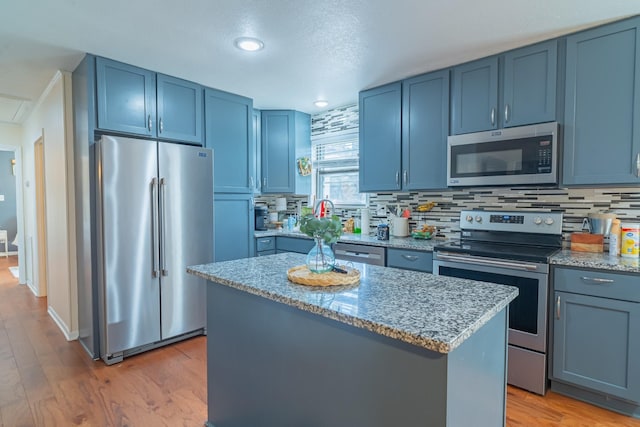 1689 Pleasant Ridge Rd, Huntland, TN 37345 - kitchen featuring stainless steel appliances, a kitchen island, blue cabinets, and backsplash