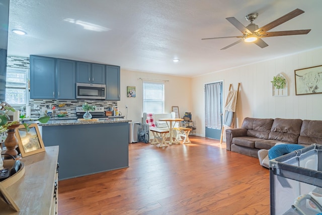 1689 Pleasant Ridge Rd, Huntland, TN 37345 - living area featuring healthy amount of natural light, wood finished floors, and a ceiling fan