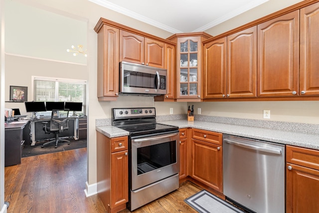 1002 Bradby Dr, Burns, TN 37029 - kitchen with stainless steel appliances, glass insert cabinets, dark wood-type flooring, crown molding, and a desk
