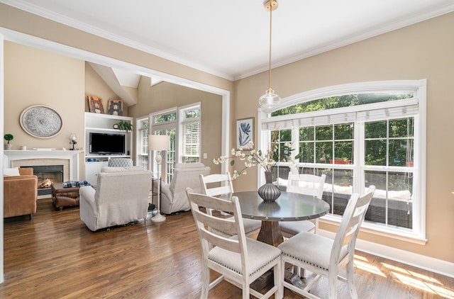 1002 Bradby Dr, Burns, TN 37029 - dining room with a lit fireplace, dark wood-style floors, ornamental molding, built in shelves, and baseboards