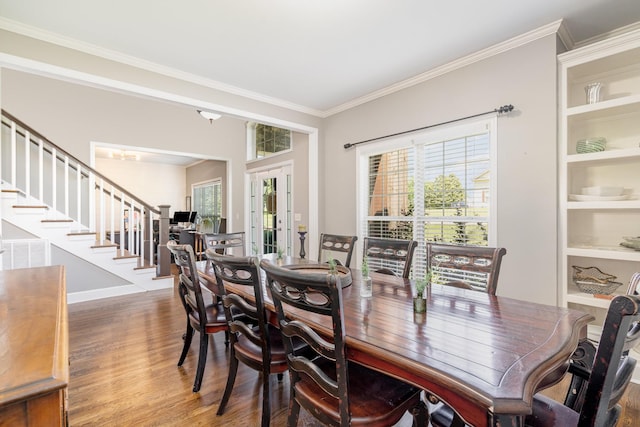 1002 Bradby Dr, Burns, TN 37029 - dining space with stairway, wood finished floors, crown molding, and french doors