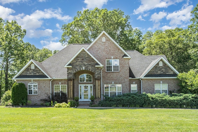 1002 Bradby Dr, Burns, TN 37029 - view of front of home featuring a front lawn, brick siding, french doors, and roof with shingles