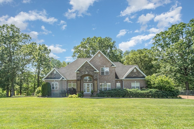1002 Bradby Dr, Burns, TN 37029 - view of front of home featuring brick siding, a front lawn, and french doors