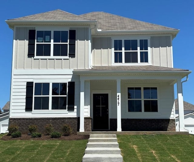 4417 Maxwell Rd, Antioch, TN 37013 - view of front of home with board and batten siding, a front lawn, and a porch