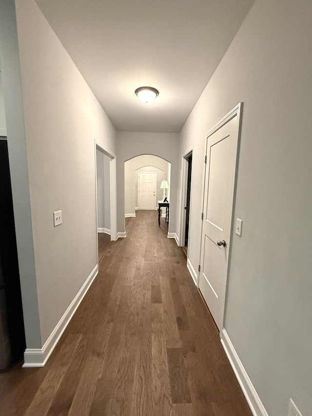 107 Auxley Ct, White House, TN 37188 - hallway with arched walkways, dark wood-type flooring, and baseboards