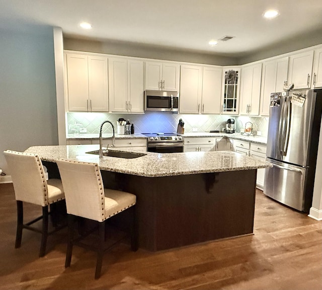107 Auxley Ct, White House, TN 37188 - kitchen with appliances with stainless steel finishes, a sink, white cabinetry, backsplash, and recessed lighting