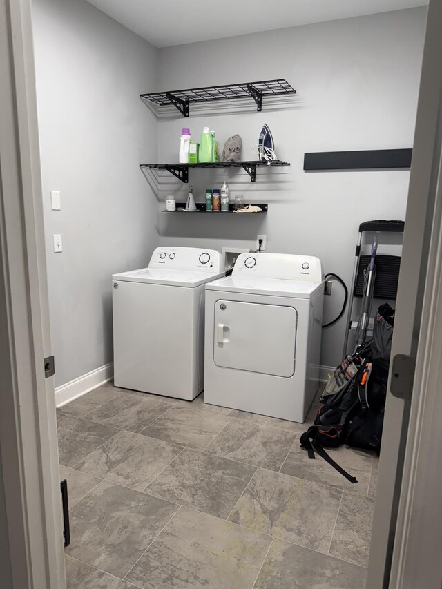 107 Auxley Ct, White House, TN 37188 - clothes washing area featuring separate washer and dryer, stone finish flooring, and baseboards