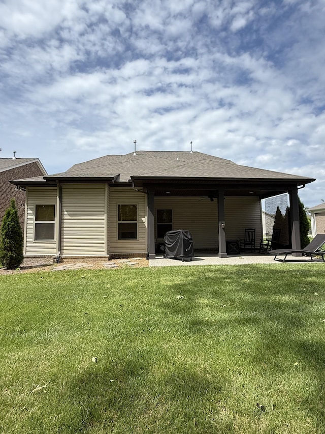 107 Auxley Ct, White House, TN 37188 - back of house featuring a patio area, a lawn, and a shingled roof