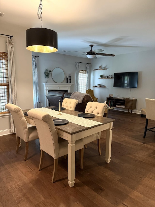 107 Auxley Ct, White House, TN 37188 - dining area featuring dark wood-style floors, a fireplace, ceiling fan, and baseboards