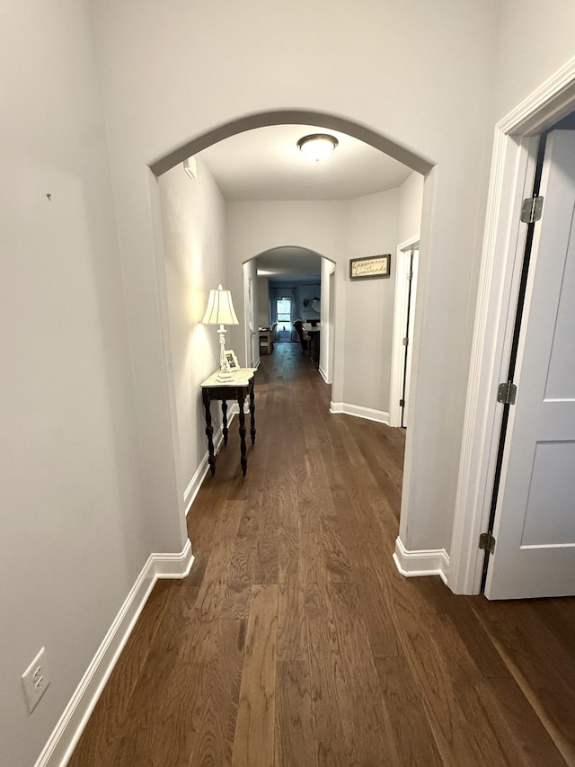 107 Auxley Ct, White House, TN 37188 - hallway with arched walkways, dark wood-style flooring, and baseboards