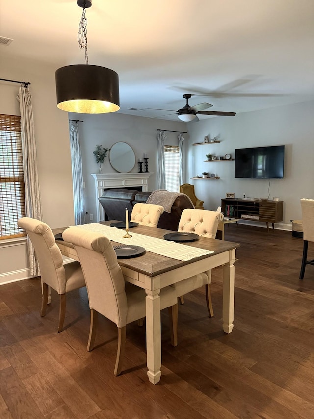 107 Auxley Ct, White House, TN 37188 - dining room with a fireplace, dark wood-type flooring, ceiling fan, and baseboards