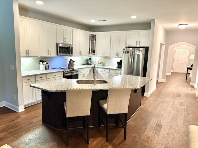 107 Auxley Ct, White House, TN 37188 - kitchen with stainless steel appliances, a sink, arched walkways, dark wood finished floors, and recessed lighting