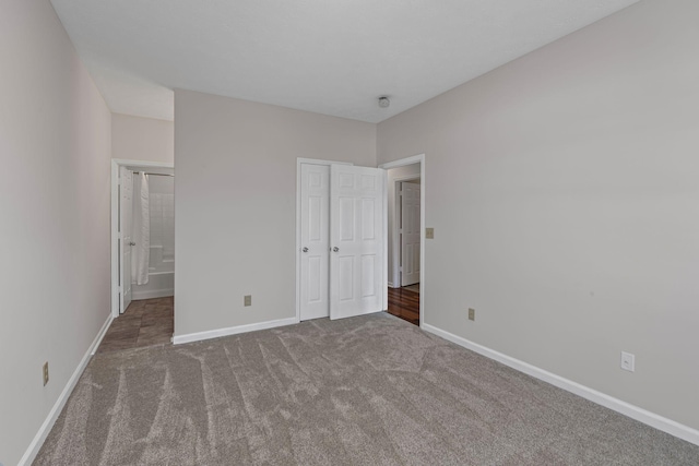 612 Churchill Xing, Madison, TN 37115 - unfurnished bedroom featuring carpet floors, baseboards, connected bathroom, and a closet
