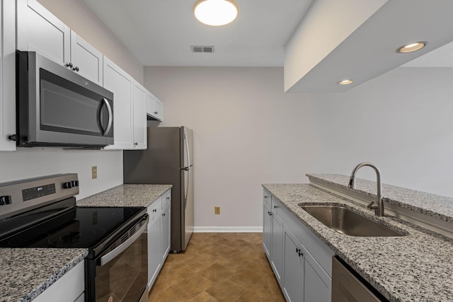 612 Churchill Xing, Madison, TN 37115 - kitchen with appliances with stainless steel finishes, a sink, light stone counters, white cabinetry, and recessed lighting