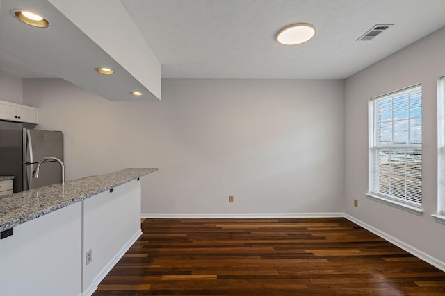 612 Churchill Xing, Madison, TN 37115 - kitchen featuring freestanding refrigerator, dark wood finished floors, baseboards, recessed lighting, and light stone countertops
