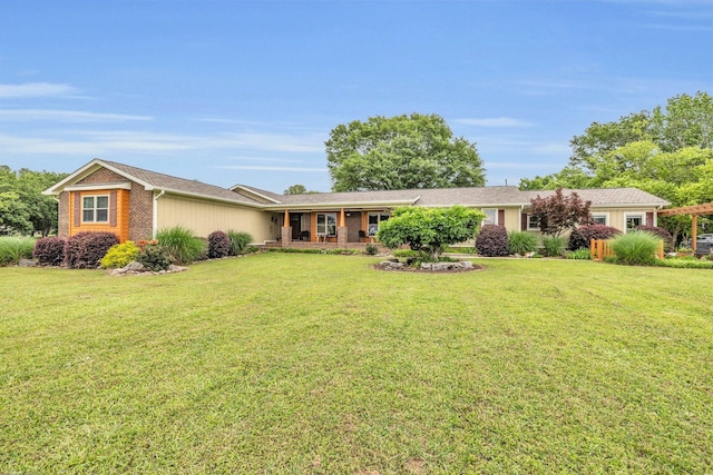 ranch-style home featuring a front yard and brick siding