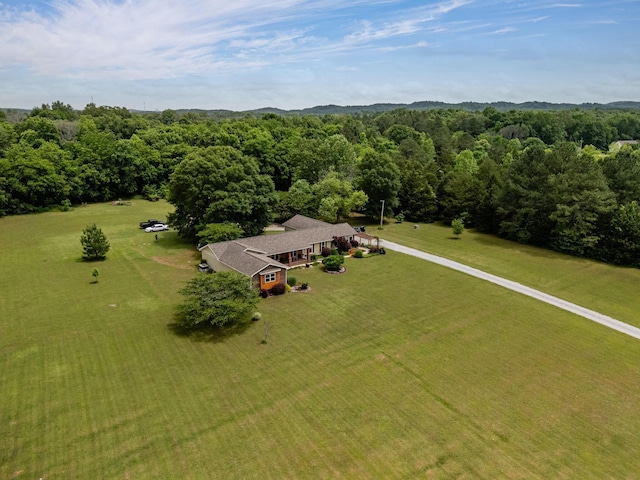 view of subject property with a heavily wooded area