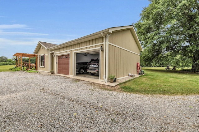 view of side of home featuring a yard and gravel driveway
