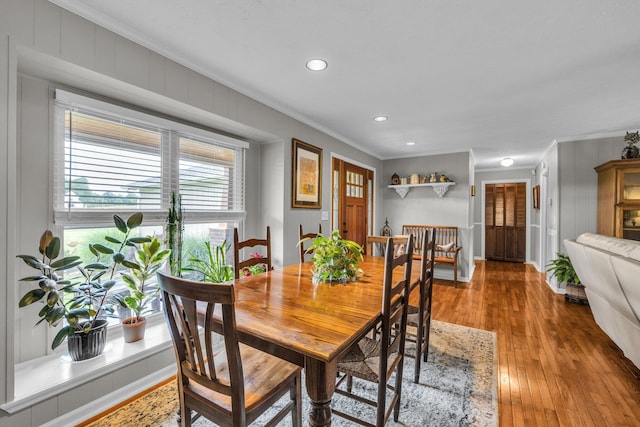 dining space featuring ornamental molding, wood-type flooring, and recessed lighting