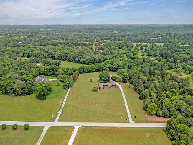 aerial view of sparsely populated area featuring a forest