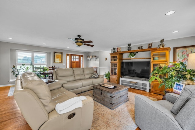 living area featuring a ceiling fan, wood finished floors, recessed lighting, and crown molding