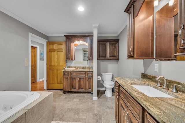 bathroom with ornamental molding, two vanities, baseboards, a jetted tub, and toilet