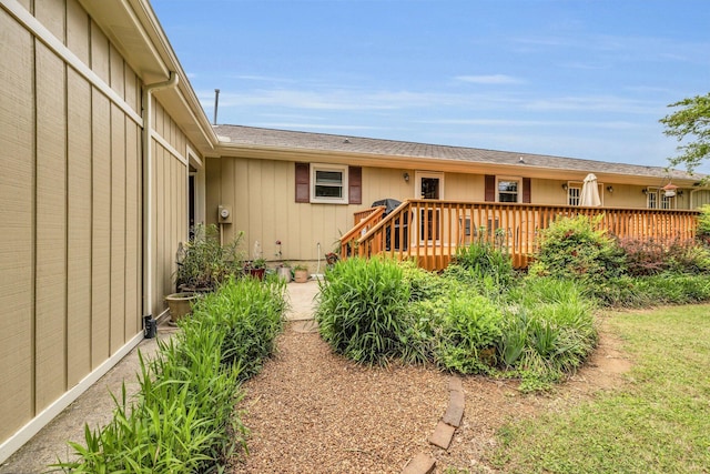 rear view of property with a wooden deck