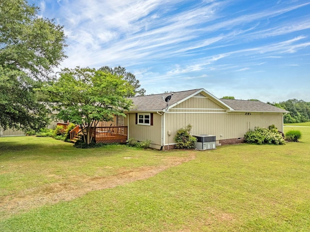 rear view of property with a wooden deck, crawl space, a lawn, and central AC unit
