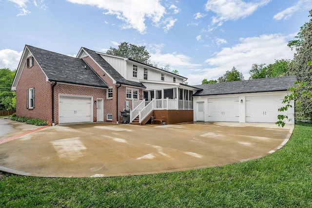 819 N Jefferson Ave, Cookeville, TN 38501 - view of front of house featuring a sunroom, brick siding, a garage, and roof with shingles