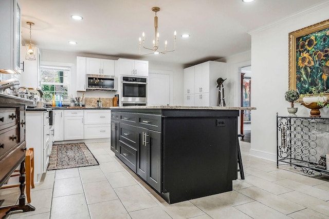 819 N Jefferson Ave, Cookeville, TN 38501 - kitchen with stainless steel appliances, dark cabinets, white cabinetry, crown molding, and a kitchen island