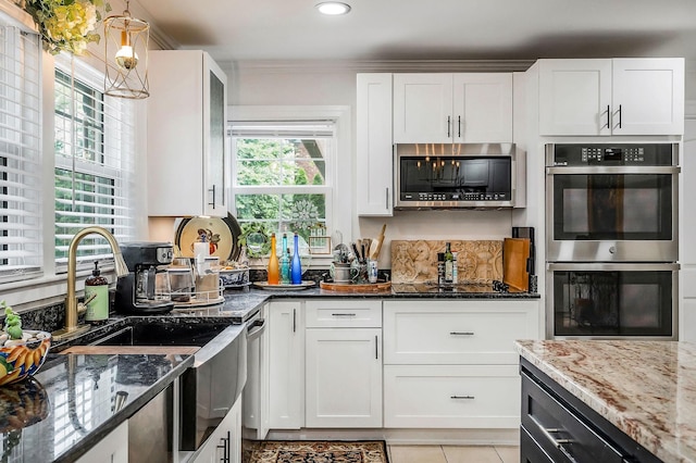 819 N Jefferson Ave, Cookeville, TN 38501 - kitchen featuring stainless steel appliances, a sink, dark stone countertops, white cabinetry, and ornamental molding