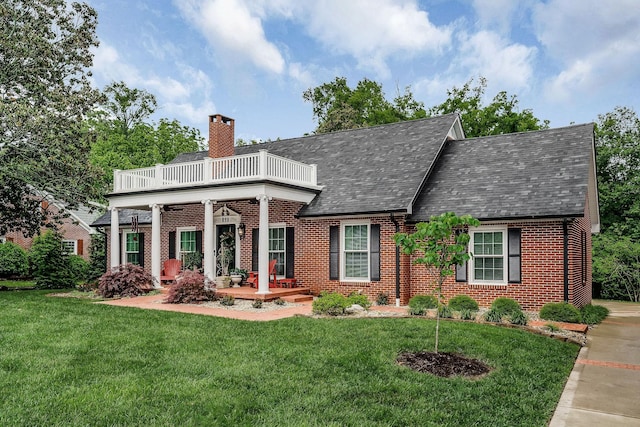 819 N Jefferson Ave, Cookeville, TN 38501 - view of front facade featuring brick siding, a balcony, a chimney, and a front yard