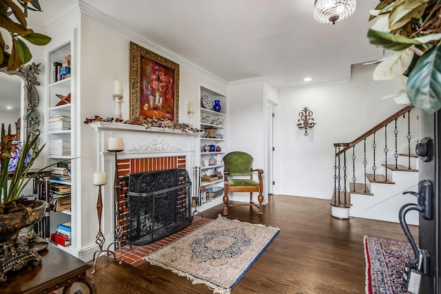 819 N Jefferson Ave, Cookeville, TN 38501 - living area with stairway, built in features, a brick fireplace, wood finished floors, and crown molding