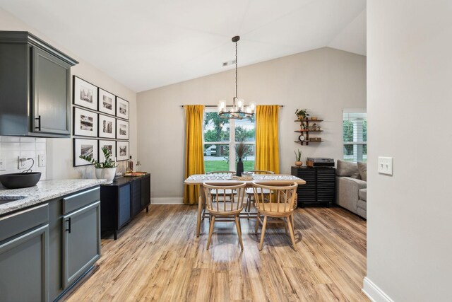 143 Two Mile Pike, Goodlettsville, TN 37072 - dining room with healthy amount of natural light, light wood-type flooring, lofted ceiling, a chandelier, and baseboards