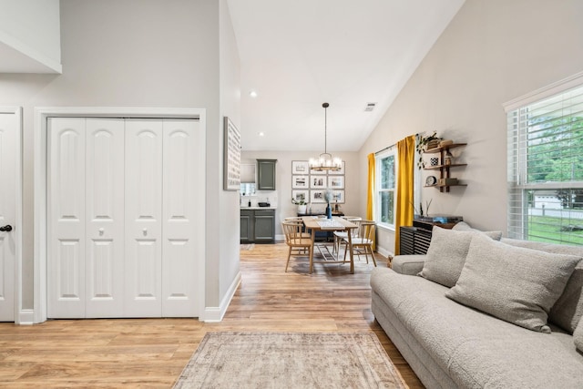 143 Two Mile Pike, Goodlettsville, TN 37072 - living area with a chandelier, light wood finished floors, high vaulted ceiling, and baseboards