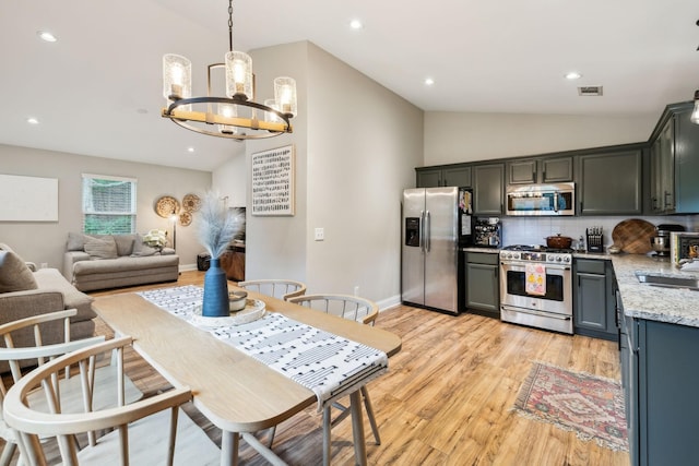 143 Two Mile Pike, Goodlettsville, TN 37072 - kitchen with appliances with stainless steel finishes, a chandelier, lofted ceiling, tasteful backsplash, and light wood-style floors