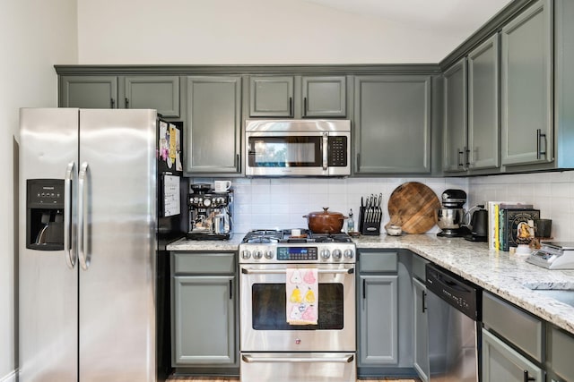 143 Two Mile Pike, Goodlettsville, TN 37072 - kitchen featuring stainless steel appliances, tasteful backsplash, lofted ceiling, and light stone counters