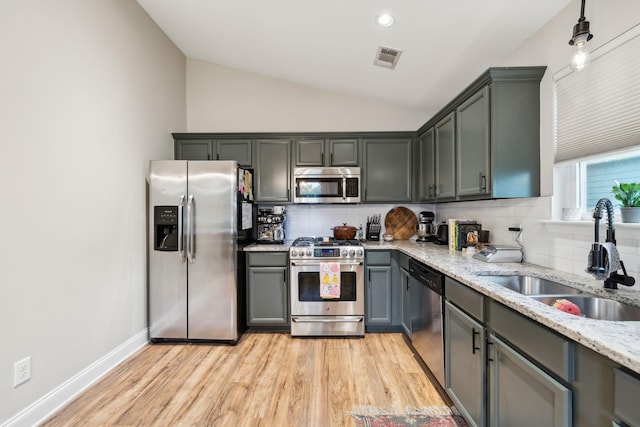 143 Two Mile Pike, Goodlettsville, TN 37072 - kitchen featuring appliances with stainless steel finishes, a sink, backsplash, light stone countertops, and light wood finished floors