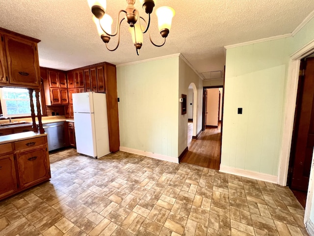 565 E College St, Pulaski, TN 38478 - kitchen featuring freestanding refrigerator, light countertops, baseboards, arched walkways, and a chandelier