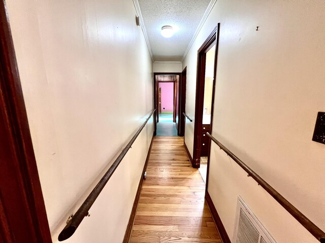 565 E College St, Pulaski, TN 38478 - corridor featuring light wood-style floors, crown molding, and a textured ceiling