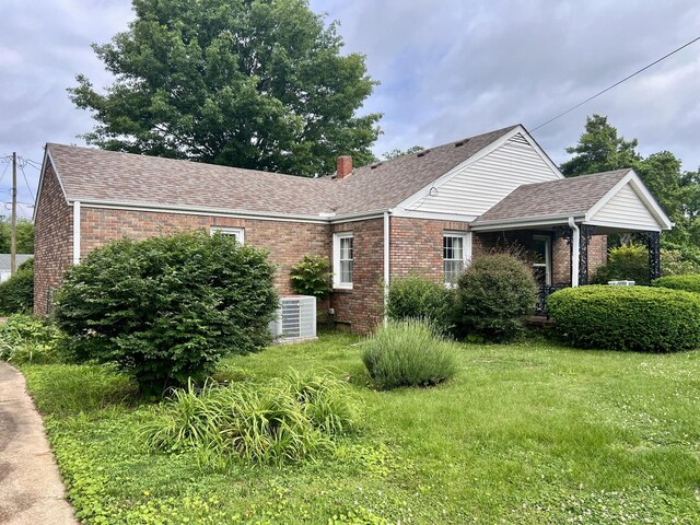 565 E College St, Pulaski, TN 38478 - view of front of home with brick siding, a chimney, a shingled roof, and a front lawn