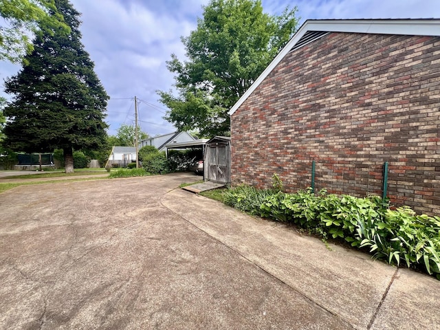 565 E College St, Pulaski, TN 38478 - view of home's exterior featuring driveway and brick siding