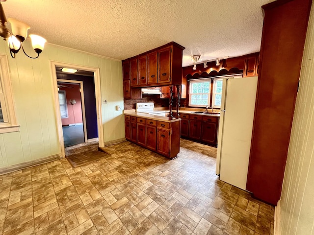565 E College St, Pulaski, TN 38478 - kitchen featuring freestanding refrigerator, range, under cabinet range hood, a sink, and light countertops