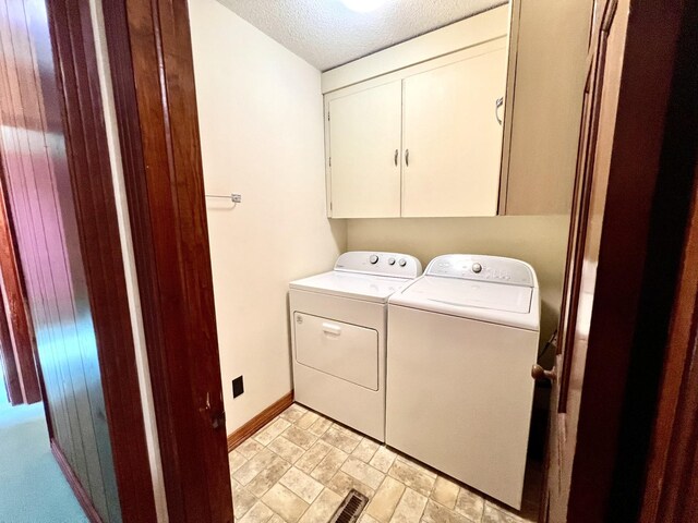 565 E College St, Pulaski, TN 38478 - laundry area featuring cabinet space, independent washer and dryer, baseboards, and a textured ceiling