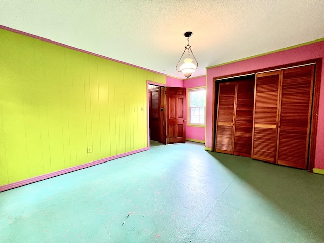 565 E College St, Pulaski, TN 38478 - unfurnished bedroom with a textured ceiling, concrete flooring, and baseboards