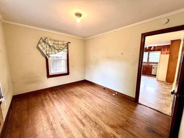 565 E College St, Pulaski, TN 38478 - unfurnished room featuring wood finished floors, ornamental molding, baseboards, a sink, and a smoke detector
