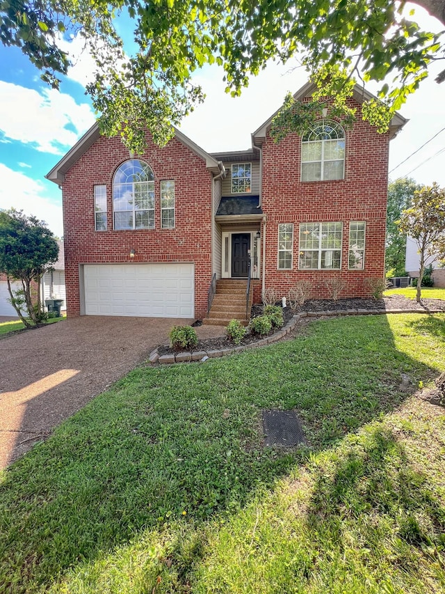 1021 Colo Trl, Antioch, TN 37013 - traditional-style home featuring a garage, asphalt driveway, a front yard, and brick siding